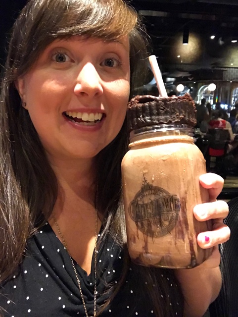 cailin enjoying a chocolate brownie milkshake at the toothsome chocolate emporium and savoury feast kitchen - A Review of The Toothsome Chocolate Emporium at Universal Orlando