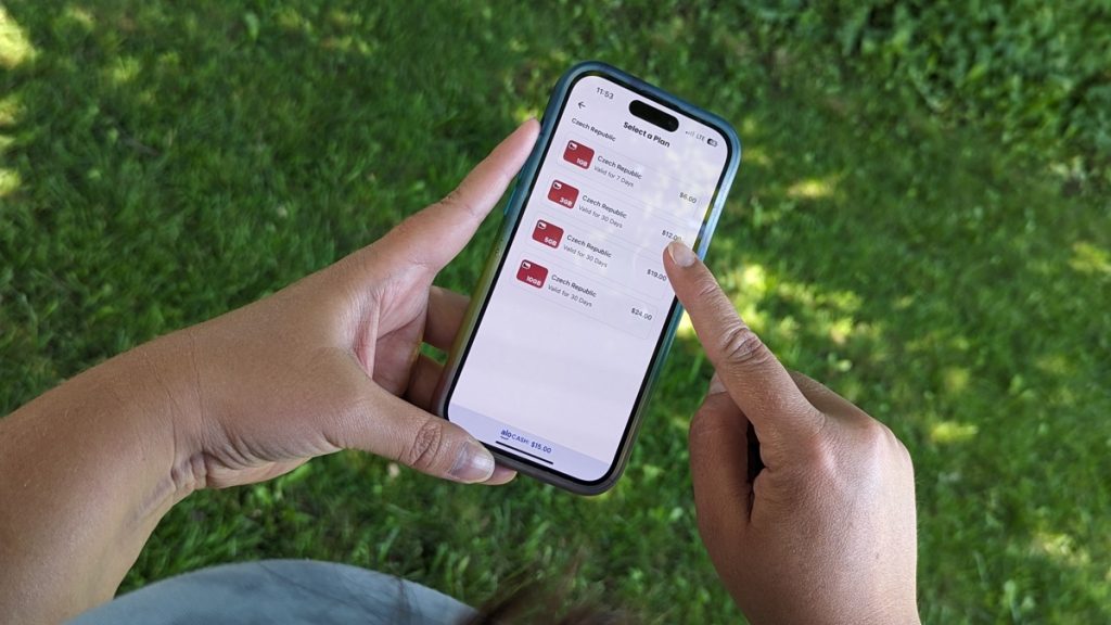 a picture of two hands holding an iphone about to download an esim for the czech republic from alosim