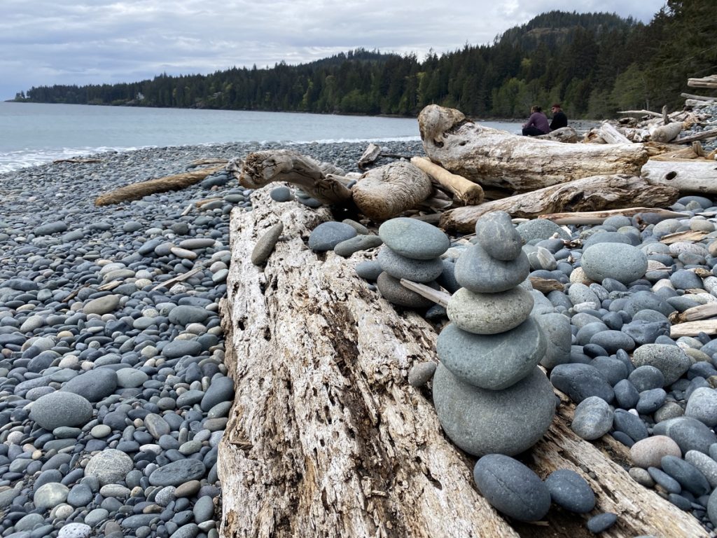 rocks stacked on french beach along the pacific marine circle route on vancouver island