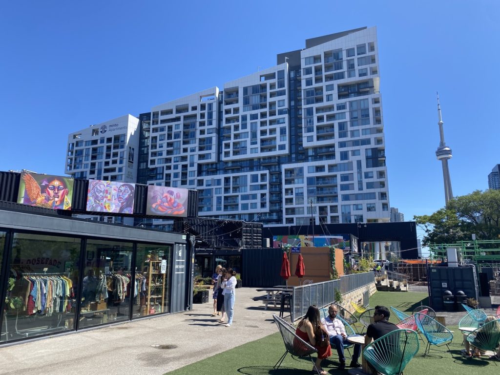 the stackt container park in downtown toronto with the cn tower in the background